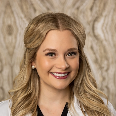 Dentist Lacy Jones Smiling In Lab Coat