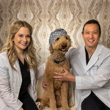 Dentists Lacy Jones And Alan Liu With Dog Smiling