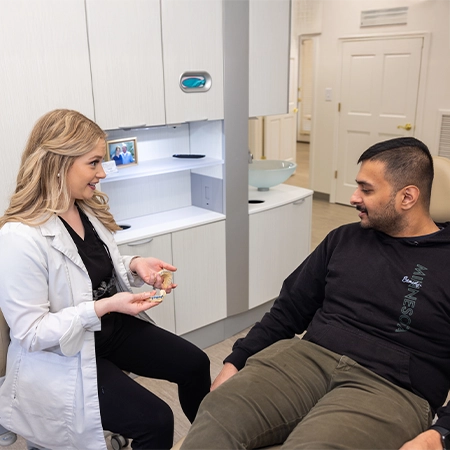 Lacy Jones Consulting With Dental Patient