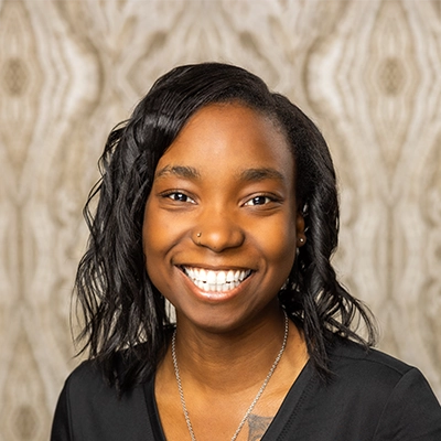 Dental Hygienist Miracle Smiling in black scrubs
